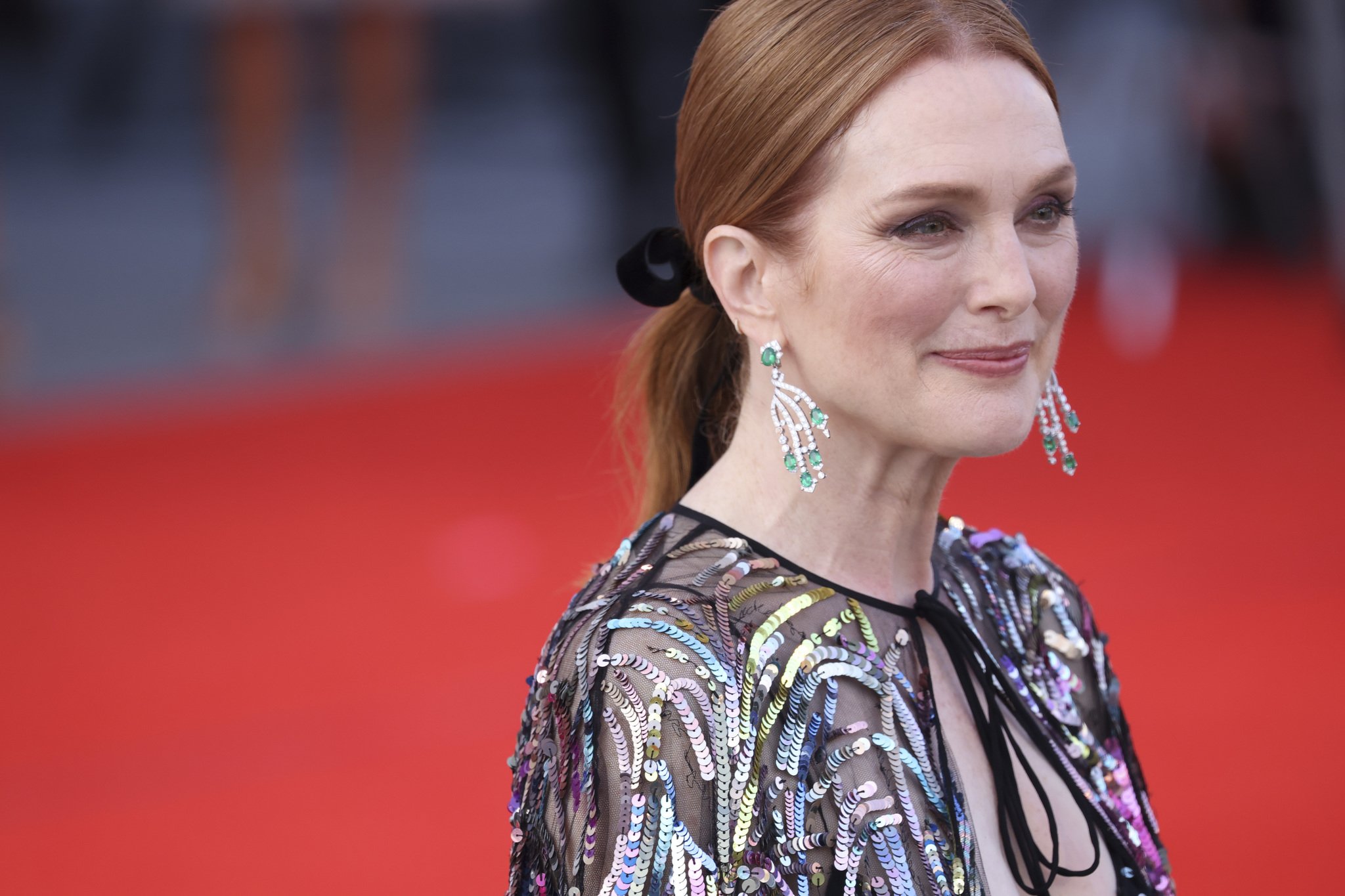 Julianne Moore in a low ponytail with a black velvet bow, soft blush and smoky eyes at the Venice Film Festival.