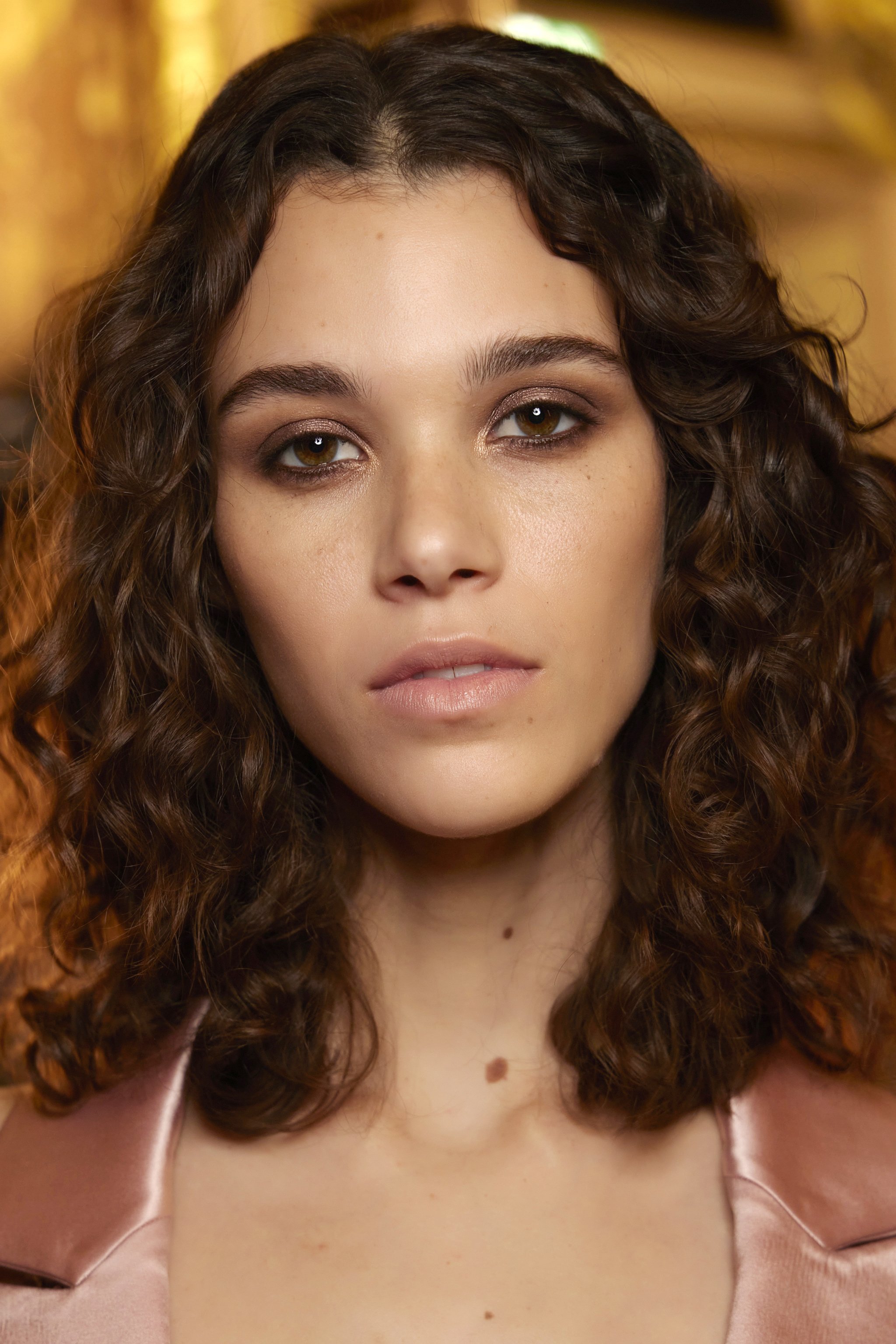 The curly clavicut can be worn at shoulder length and layered.