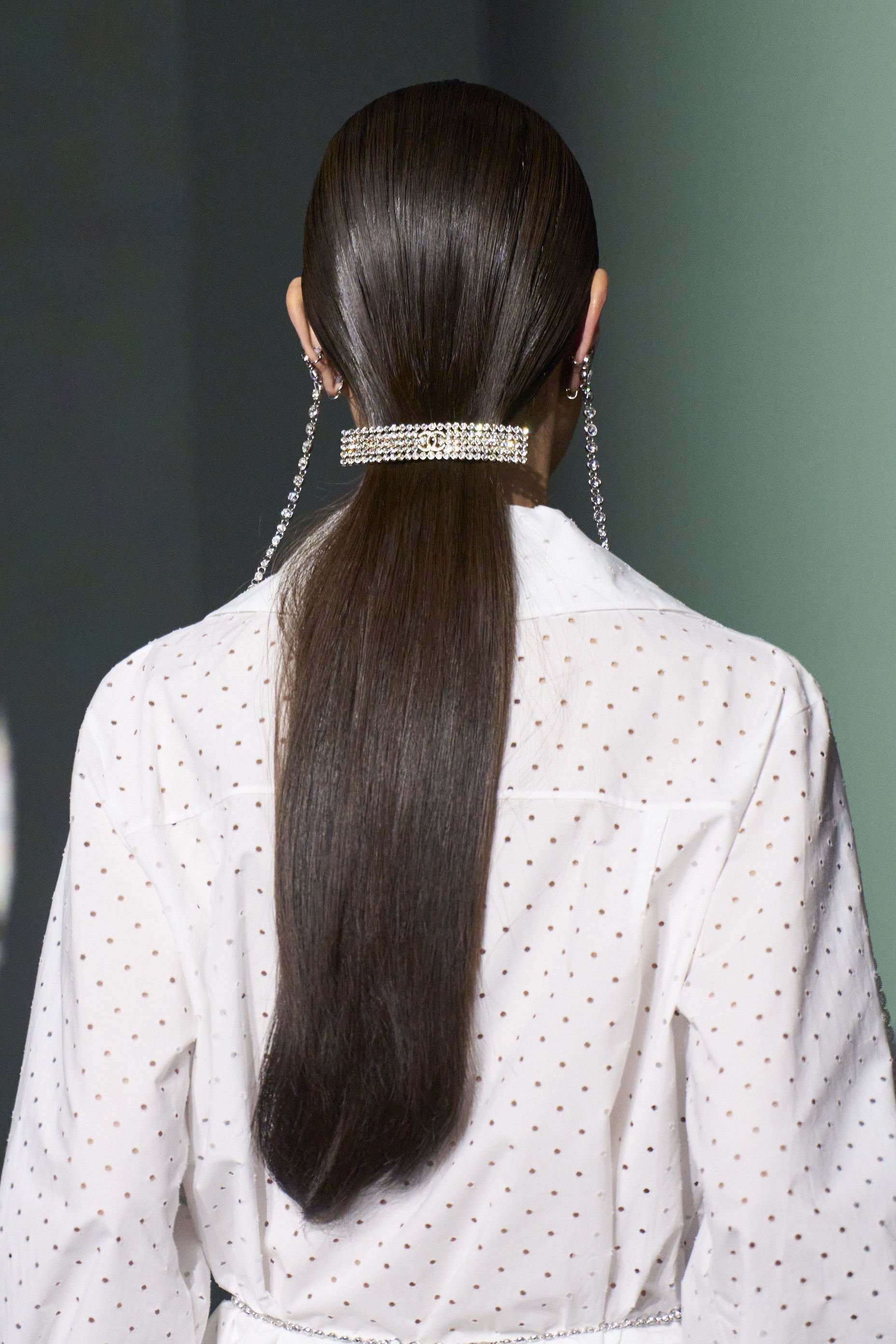 The horizontal hair clips with rhinestones and the logo on smooth and shiny hair have become our beauty objective of the season.