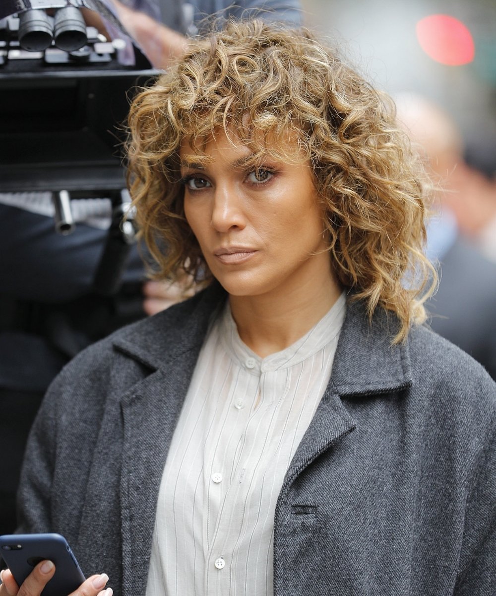Jennifer Lopez with a curly shag haircut.