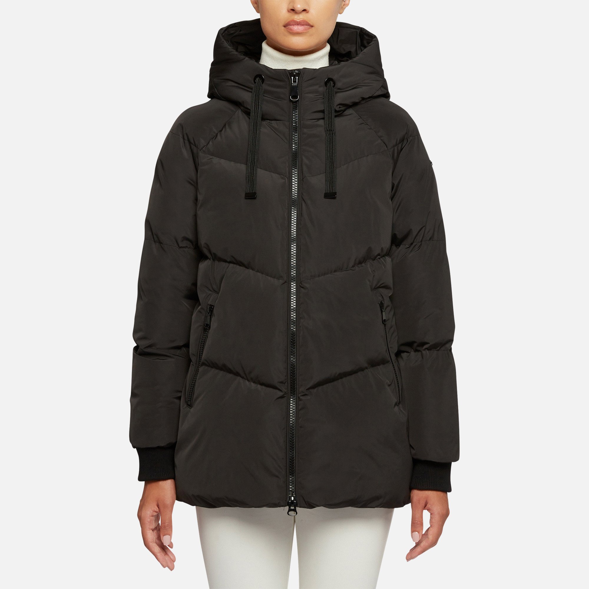 Women's long padded parka with an enveloping hood, ideal for use in cold temperatures.