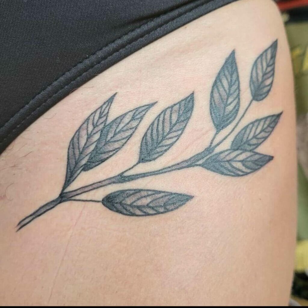 Leaf and fern tattoo on the bikini area