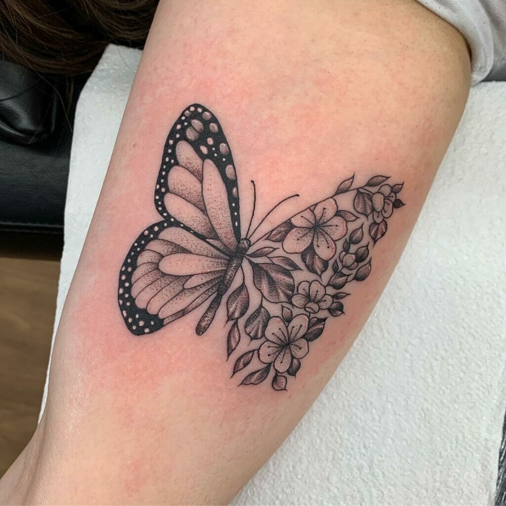 Butterfly and floral inner bicep tattoo