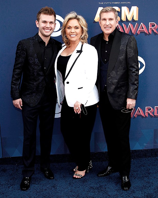 Chase Chrisley poses with his parents Julie and Todd Chrisley at the 53rd Annual Academy of Country Music Awards 2018 (Photo: Shutterstock)
