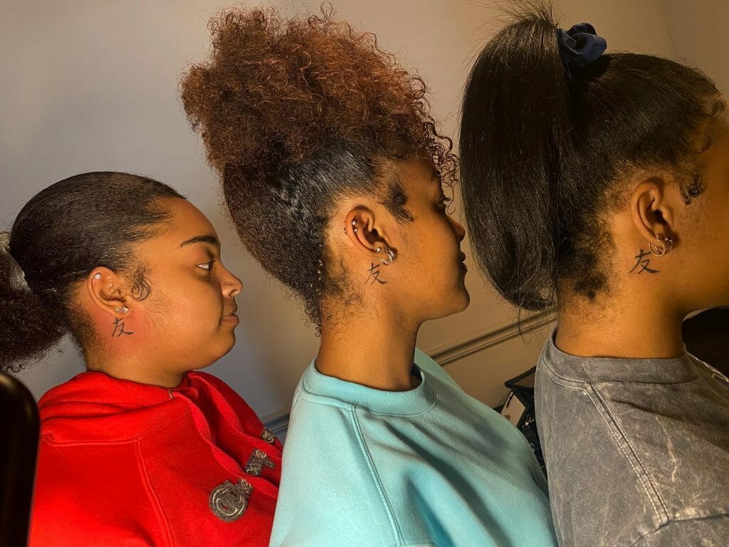 Chinese symbol tattoo behind the ear for friendship