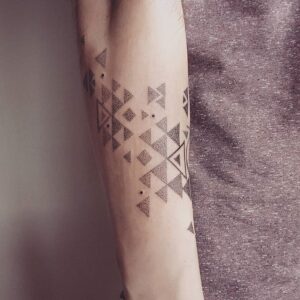 Dotwork triangles tattoo on the forearm