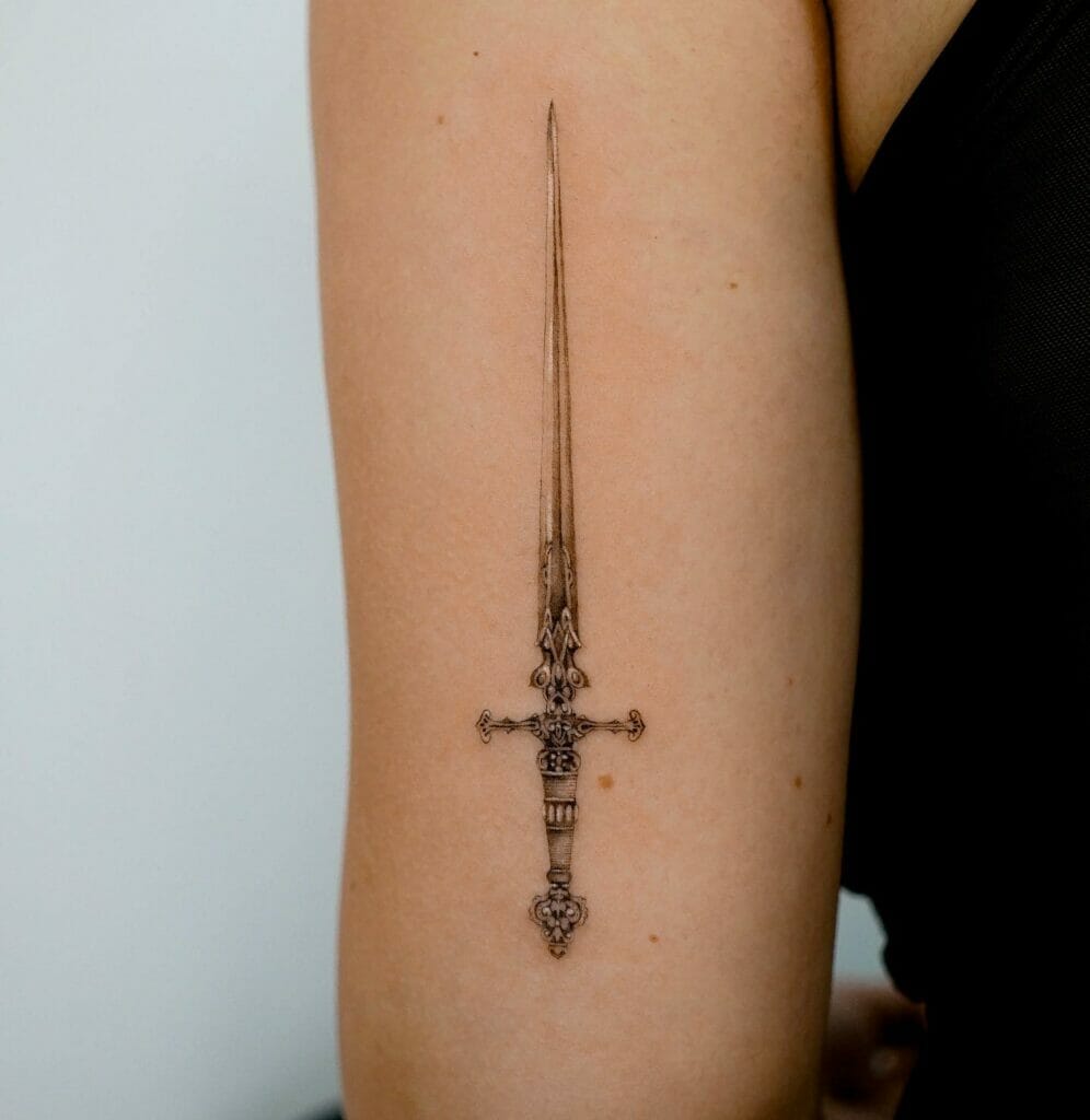 Feminine minimalist sword tattoo