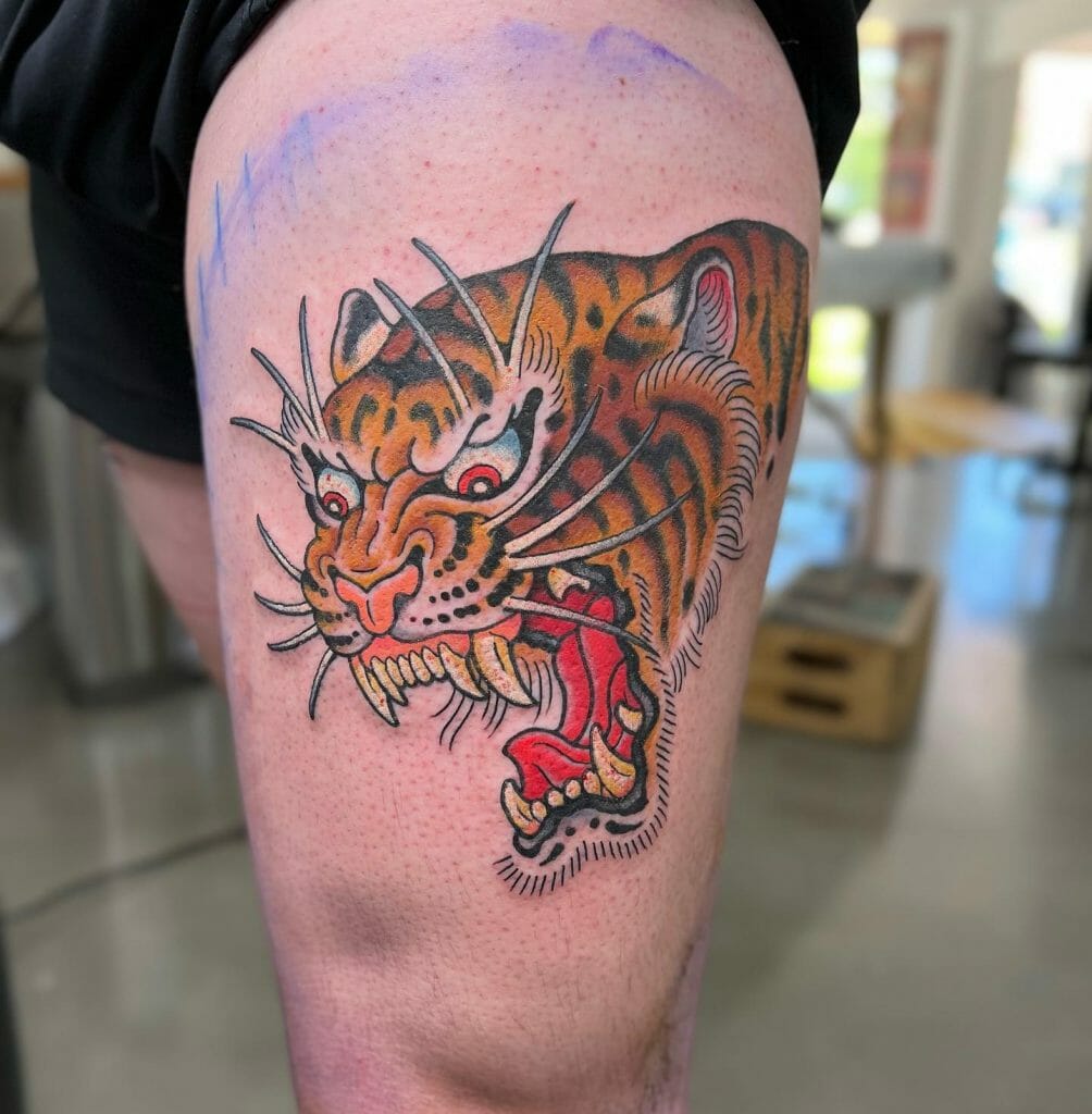 Violent tiger thigh tattoo