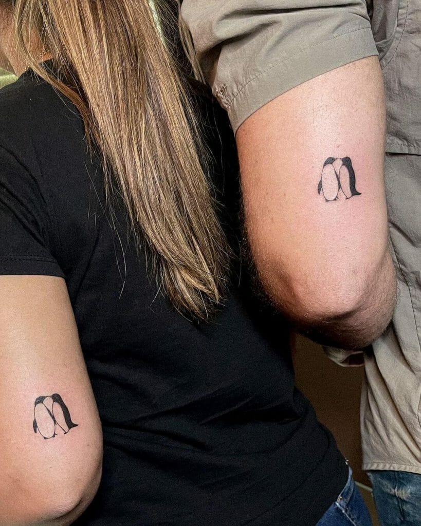 Funny couple tattoos with penguins inside