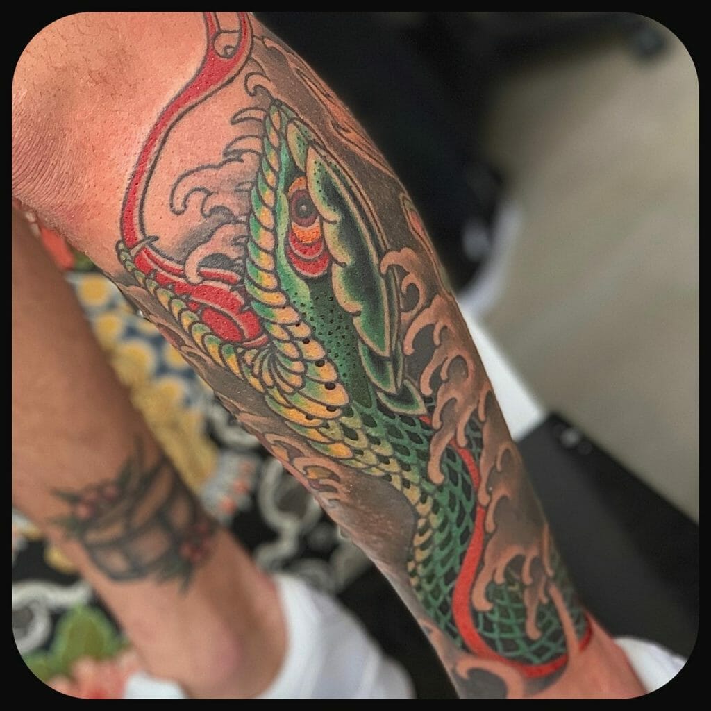 Green snake full leg sleeve tattoo
