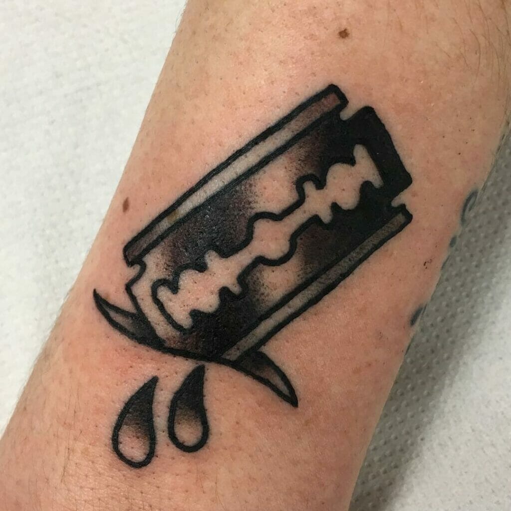 Razor blade piercing through tattoo