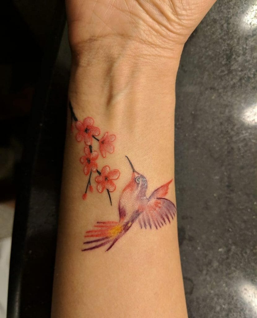 Small hummingbird with flower tattoos