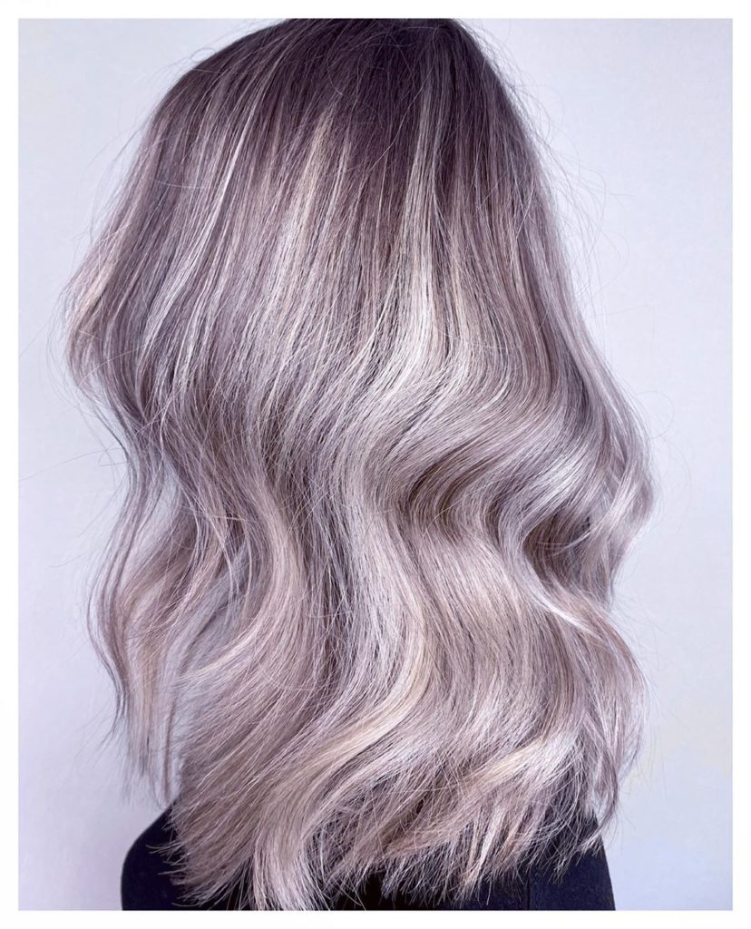 Hairstyle Ladies: Back of the head with grey, wavy hair. 