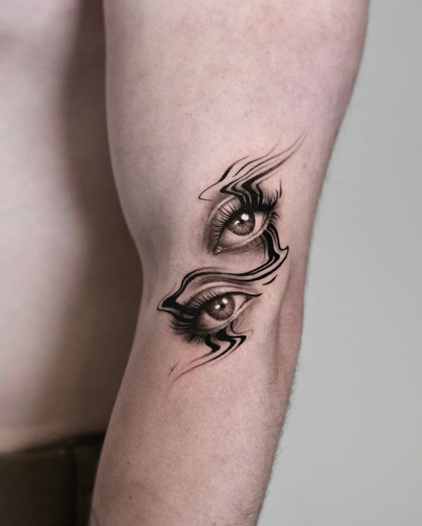 Two eye tattoos on the arm