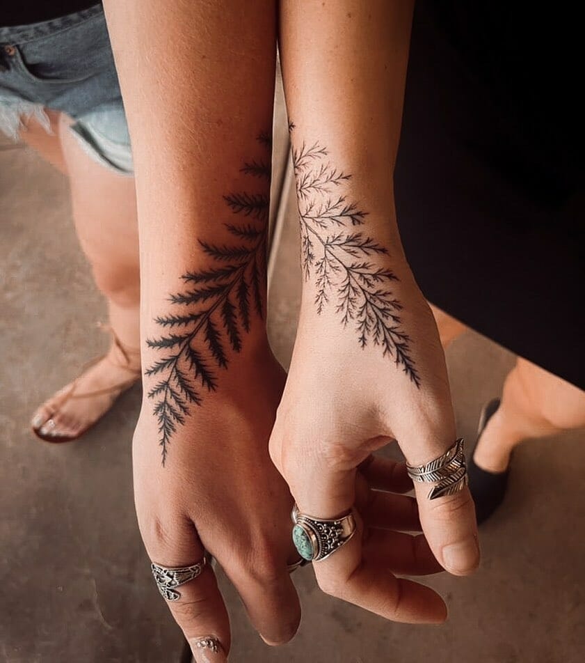 Wonderful matching tattoos with fern design