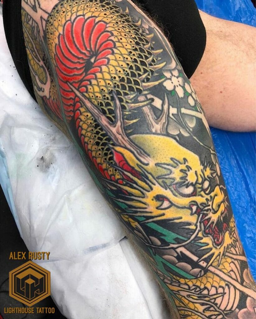 Yellow and red dragon full sleeve leg tattoo