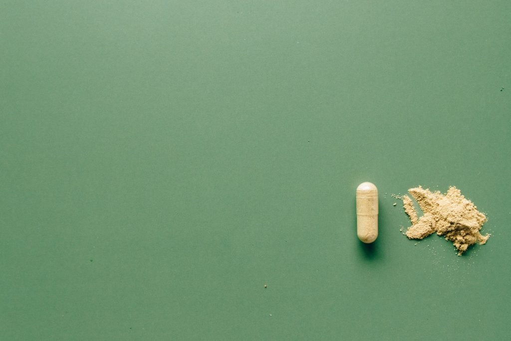 A capsule on a green surface