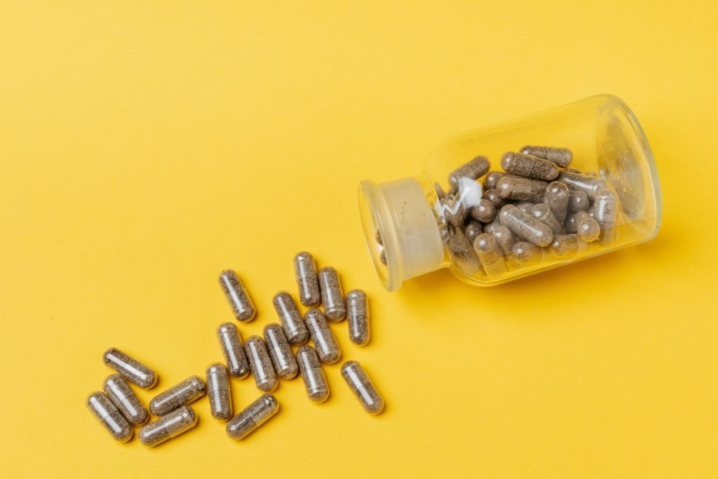Capsules pouring out of jar