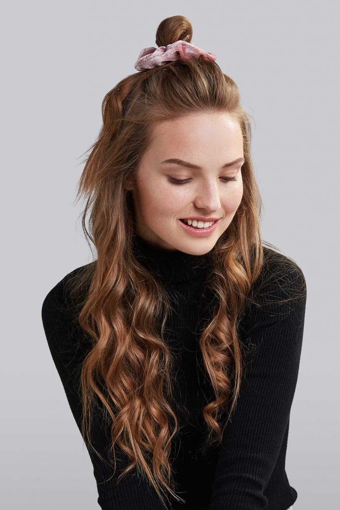You can accentuate your top knot with a weaved in braids, an unusual parting or hair accessories