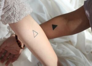 lined and all black triangle tattoo