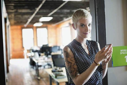 Portrait of a businesswoman using smartphone in the office