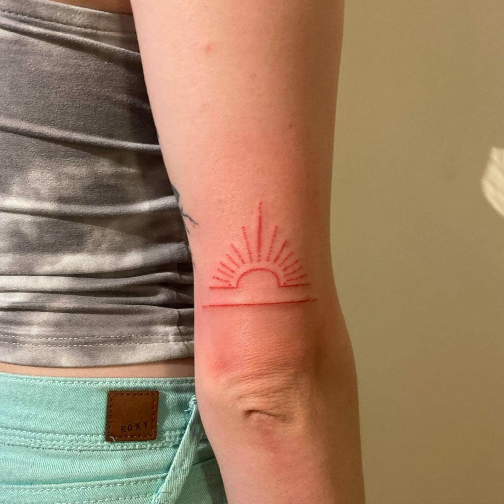 Colored rising sun tattoo