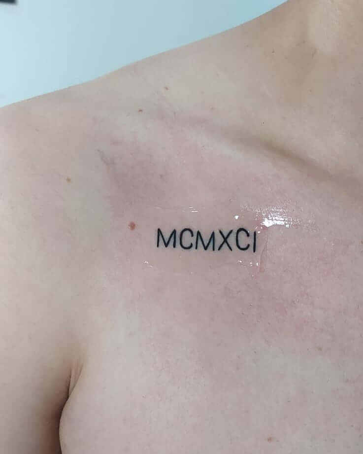 Unique roman numeral tattoo on upper chest