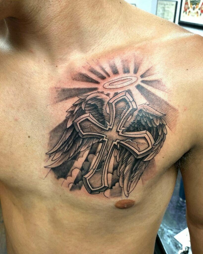 Tribal cross with wings and a halo in a cloudy background tattoo