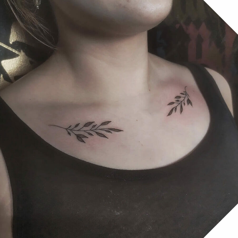 Delicate floral collarbone tattoo on both sides of the chest