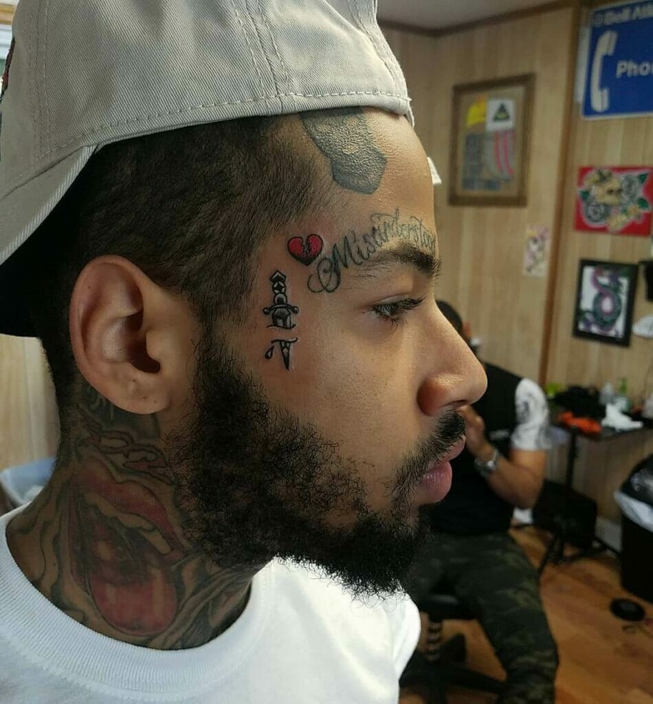 Heart tattoo on face with knife