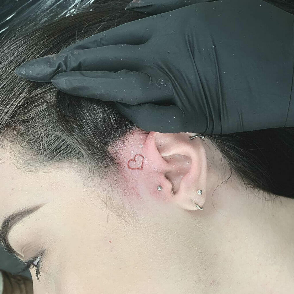 Small heart tattoo on face