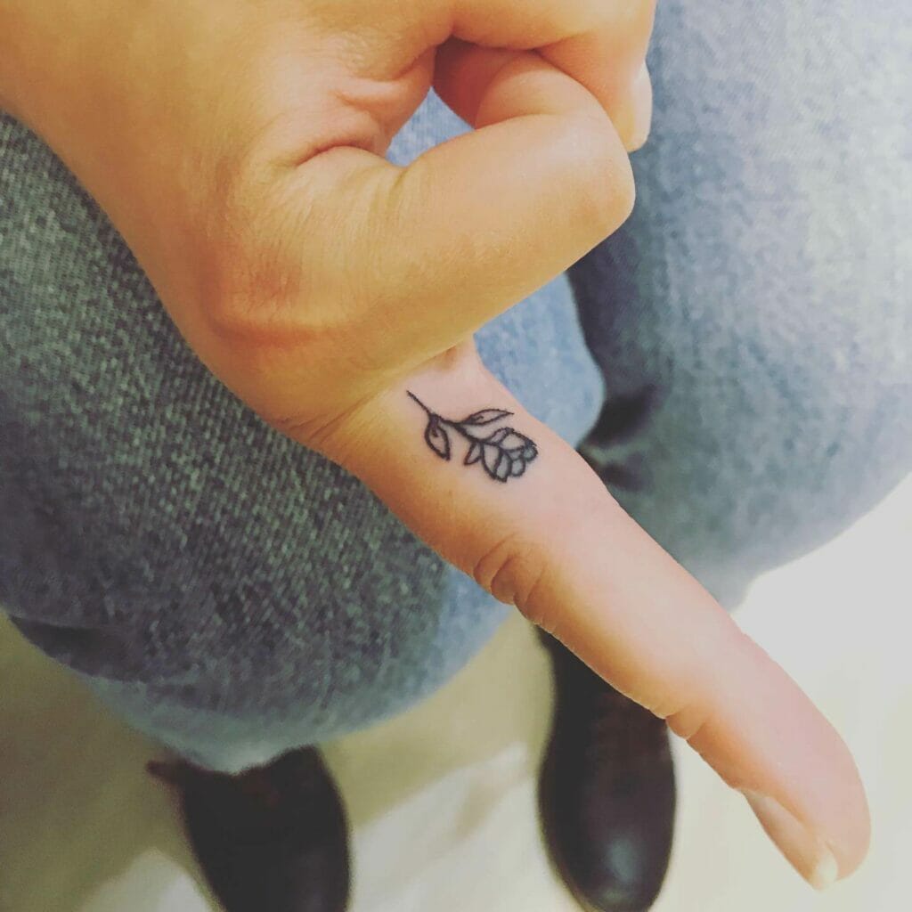Minimal rose tattoo on finger