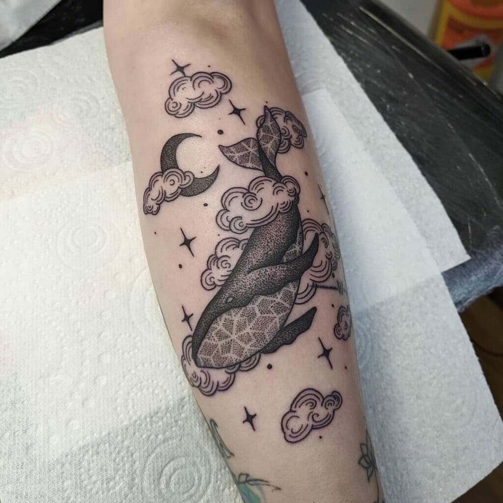 Clouds and stars tattoo with a whale design