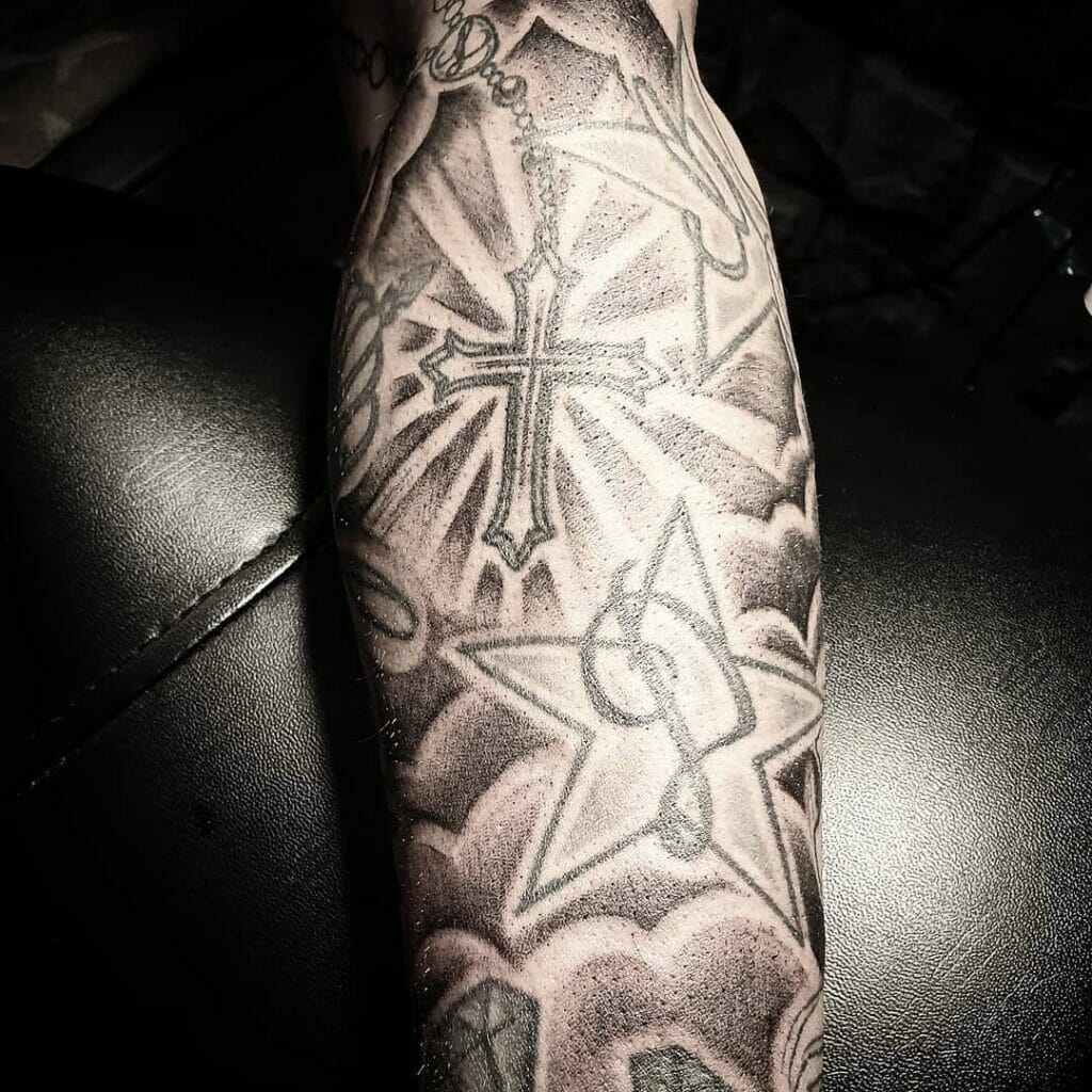 Clouds and stars tattoo with a cross