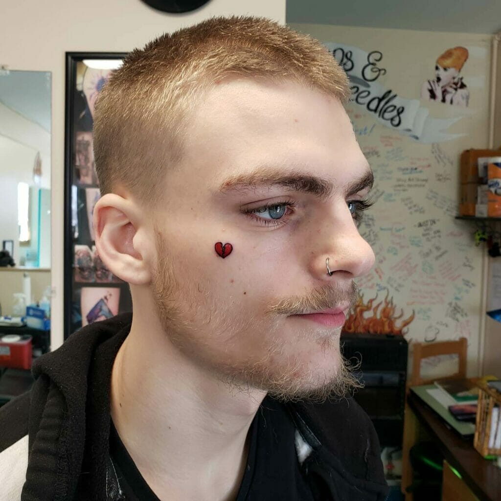 Simple heart tattoo on face