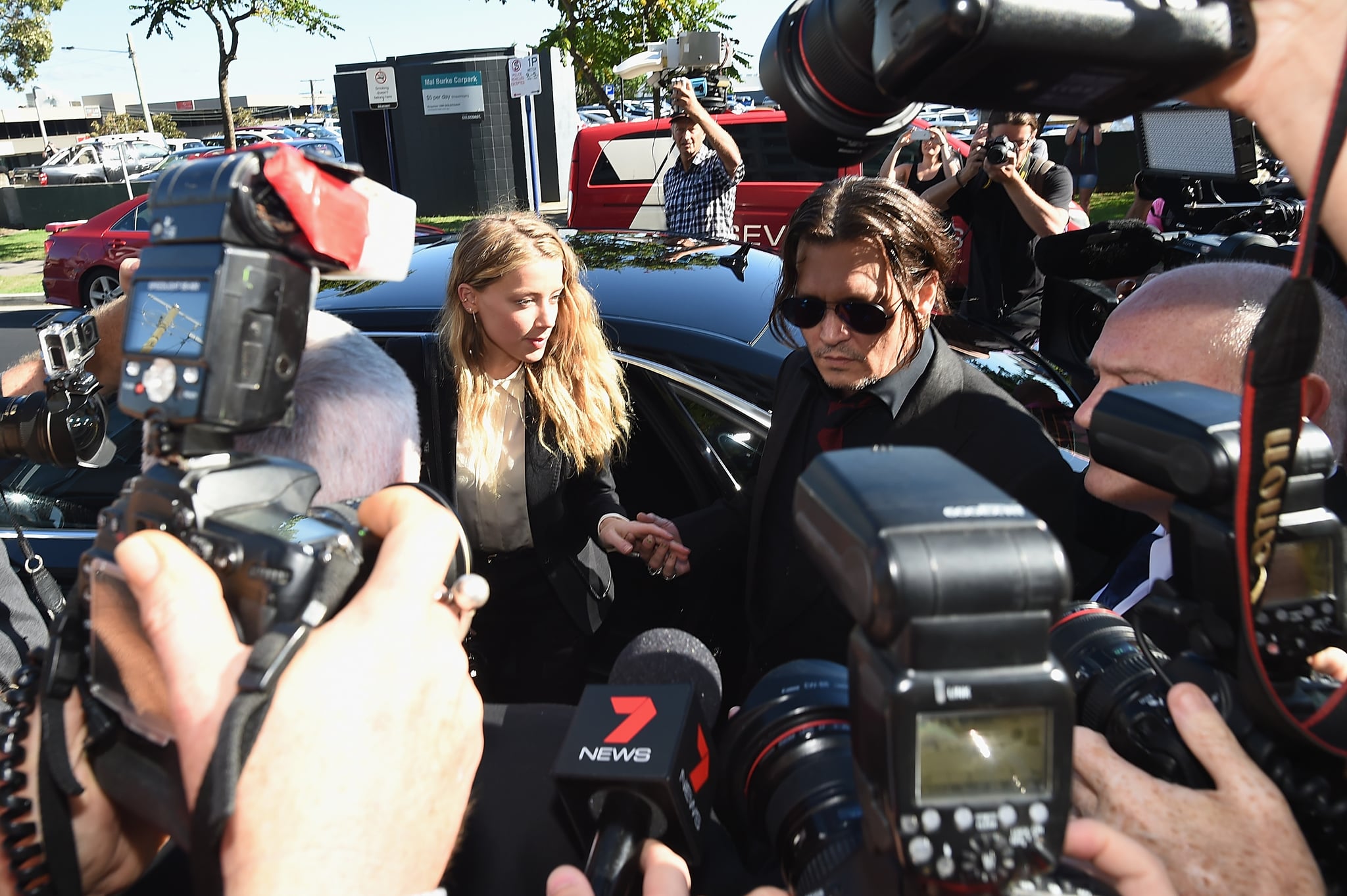 GOLD COAST, AUSTRALIA - APRIL 18: Johnny Depp and Amber Heard arrive at Southport Magistrates Court on April 18, 2016 in Gold Coast, Australia.  Heard faces two counts of violating Australia's quarantine laws by allegedly bringing her dogs, Pistol and Boo, on a private jet in May 2015.  (Photo by Matt Roberts/Getty Images)