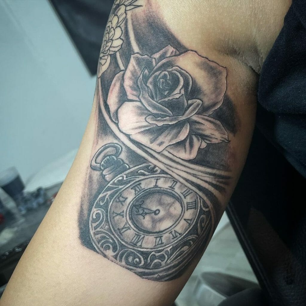 Black and gray rose tattoo with stopwatch