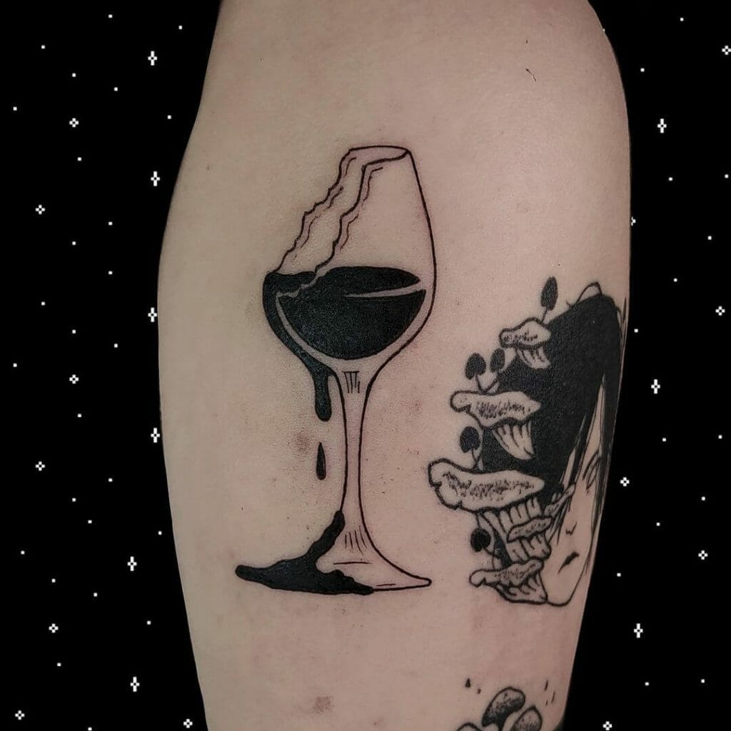 Broken red wine glass with cadaver tattoo