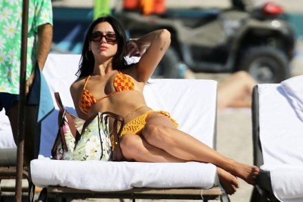 Singer Dua Lipa wears an orange bikini as she hits the beach after a sold-out concert in Miami.  February 10, 2022 Pictured: Dua Lipa.  Photo credit: MEGA TheMegaAgency.com +1 888 505 6342 (Mega Agency TagID: MEGA827166_020.jpg) [Photo via Mega Agency]