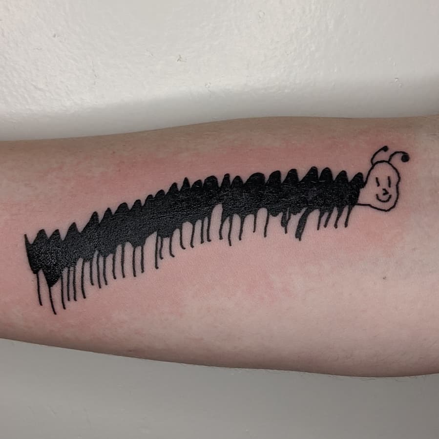 Doodle themed caterpillar tattoo