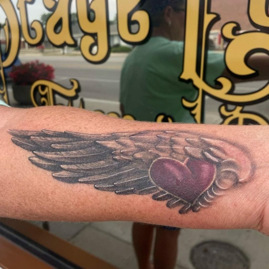 Folded angel wings and heart tattoo