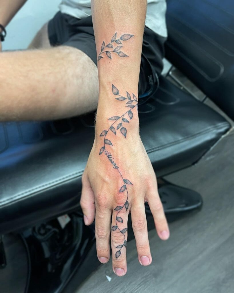 Leaf on vines around wrist and fingers tattoo