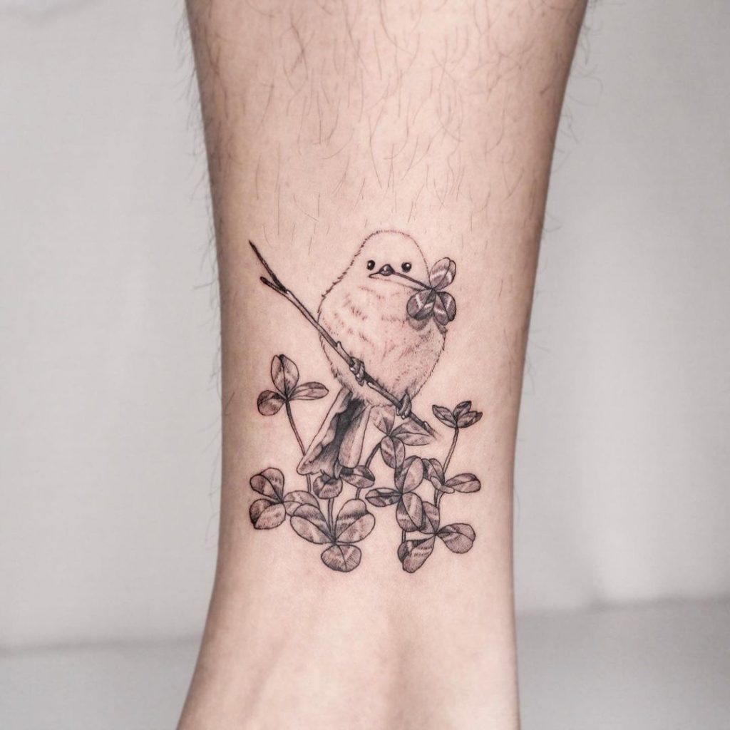 Small bird and shamrock tattoo