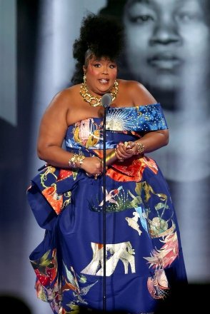2022 PEOPLE'S CHOICE AWARDS -- Pictured: Honoree Lizzo accepts the People's Champion award on stage during the 2022 People's Choice Awards held at the Barker Hangar on December 6, 2022 -- (Photo by: Rich Polk/E! Entertainment /NBC)