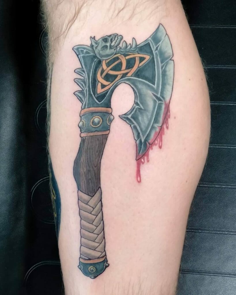 Realistic ax tattoo with hints of blood