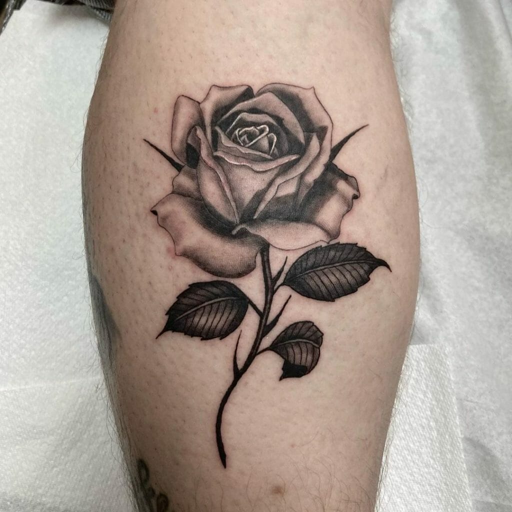 Realistic black and gray rose tattoo