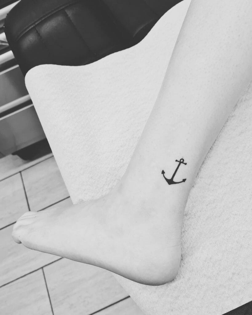 Small black anchor tattoo