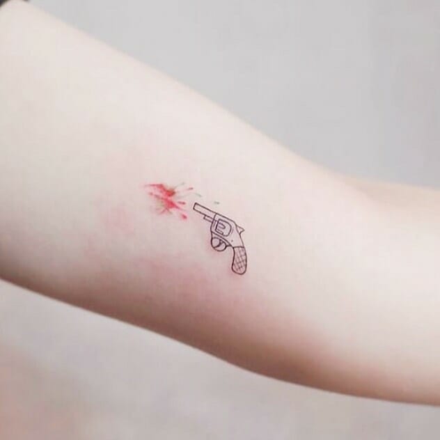 Small gun tattoo