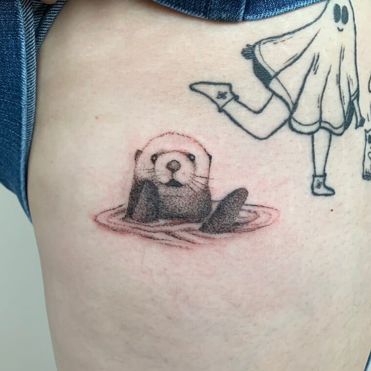 Small otter tattoo in the water