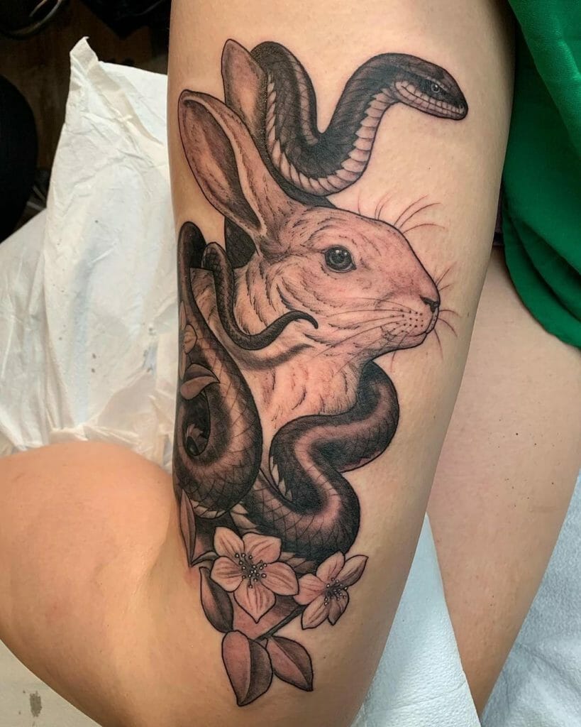 Snake and rabbit tattoo